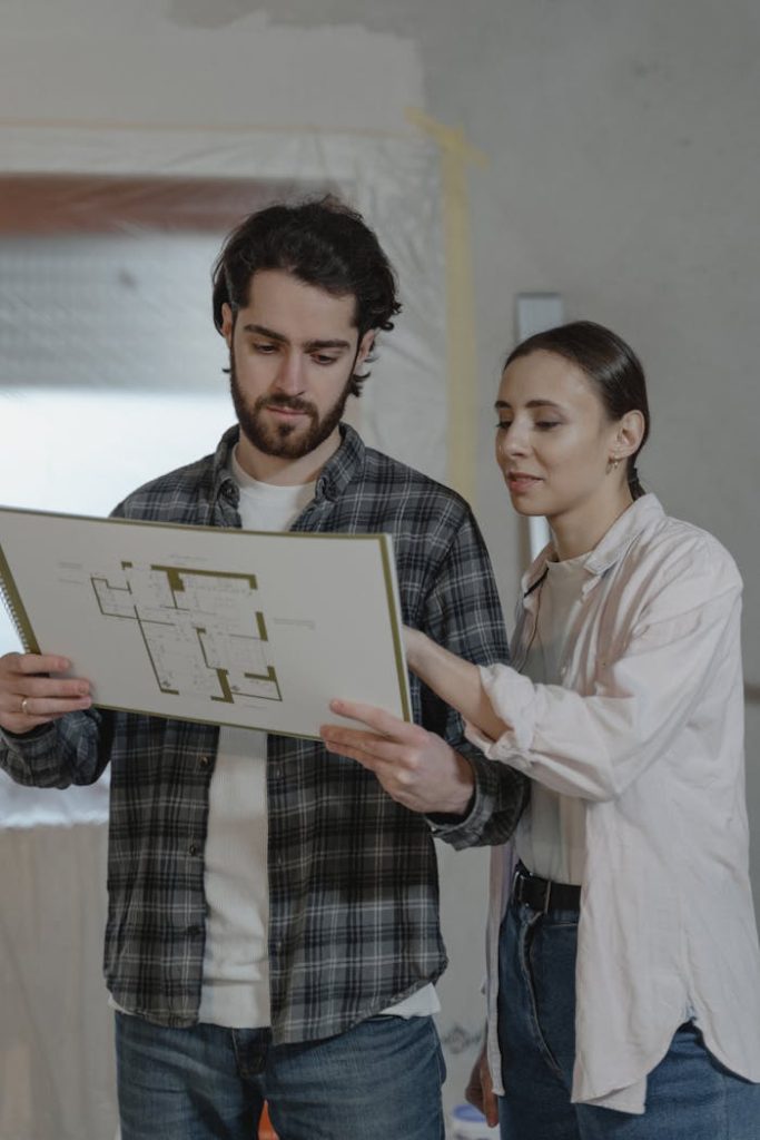 couple-looking-at-the-blueprint-6474501 A couple examines a home renovation blueprint indoors, planning improvements together.